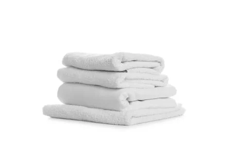 Stack of towels and bedding on white background Stock Photos