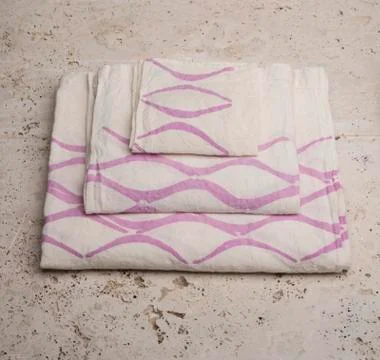 Stack of Towels with Purple Concave Lines at High Angle Stock Photos