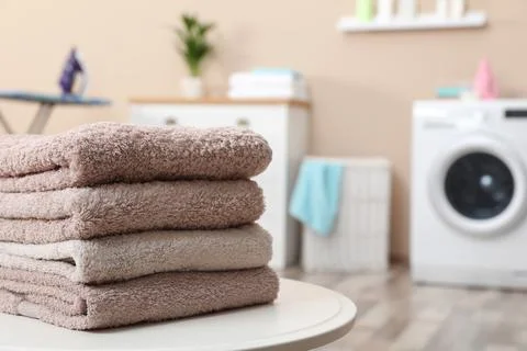 Stack of towels on table against blurred background, space for text 스톡 사진