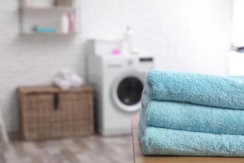 Stack of towels on table against blurred background, space for text 스톡 사진