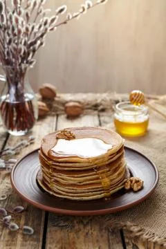 Stack of traditional American pancakes with flowing honey and nuts Stock Photos