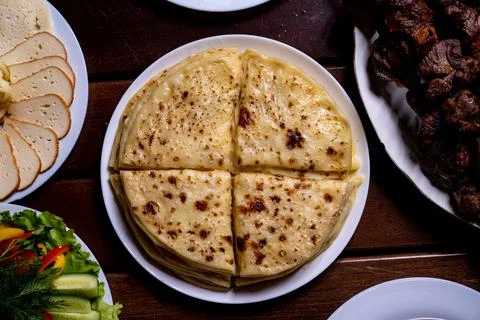 A stack of traditional Caucasian flatbreads with stuffing with mashed potatoes Stock Photos