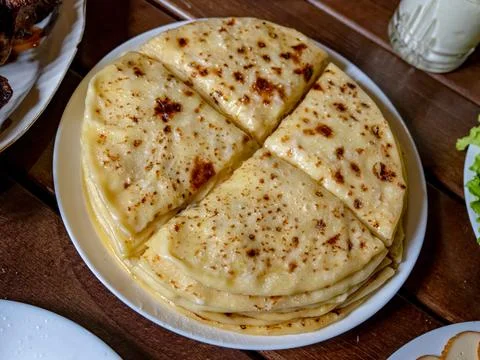 A stack of traditional Caucasian flatbreads with stuffing with mashed potatoes Stock Photos