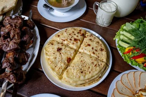 A stack of traditional Caucasian flatbreads with stuffing with mashed potatoes Stock Photos