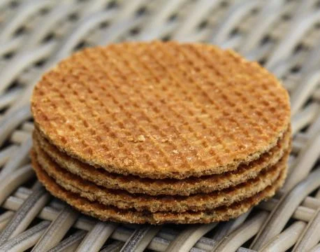 Stack of traditional dutch stroopwafels cookie, a caramel syrup waffle, on wo Stock Photos