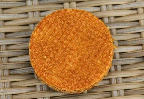 Stack of traditional dutch stroopwafels cookie, a caramel syrup waffle, on wo Stock Photos