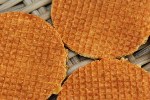 Stack of traditional dutch stroopwafels cookie, a caramel syrup waffle, on wo Stock Photos