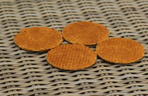 Stack of traditional dutch stroopwafels cookie, a caramel syrup waffle, on wo Stock Photos