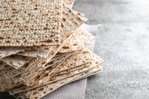 Stack of traditional matzos on grey table, closeup. Space for text Stock Photos