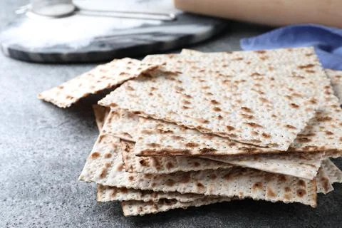 Stack of traditional matzos on grey table, closeup 스톡 사진