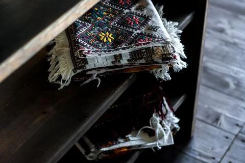 Stack of traditional woven textile rugs with ethnic patterns Stock Photos