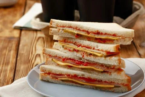 Stack of triangle sandwiches in plate close up Stock Photos
