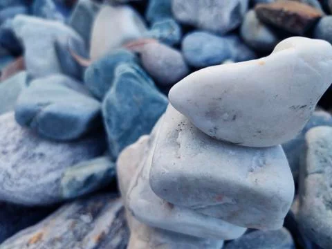 Stack of triangular stones.Group of white and colorful Stones.Pebble tower on Stock Photos