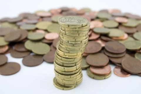 Stack twenty euro cent coins on more coins of little value. Savings of coins Stock Photos