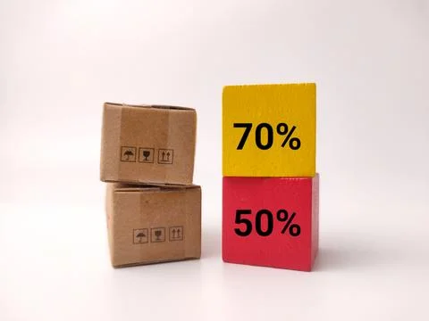A stack of two small cardboard boxes stands next to stacked yellow and red .. Stock Photos