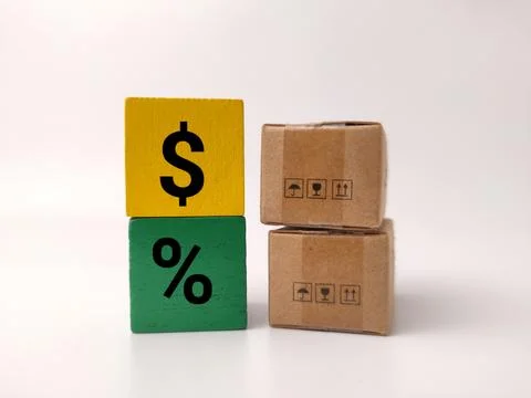 A stack of two small cardboard shipping boxes stands next to stacked yellow.. Stock Photos
