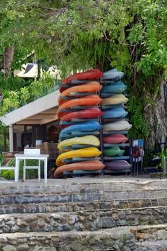 Stack of typical thai colorful kayaks stand on the seashore on Koh Chang isla Stock Photos