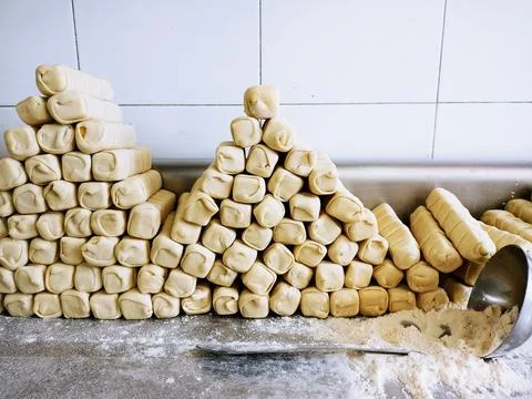 Stack of unbaked cheese sticks. Puff pastry roll or cheese fingers. latin bread Stock Photos
