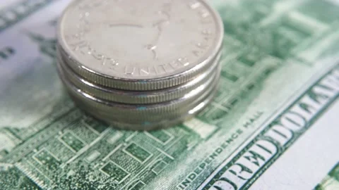 Stack of United Arab Emirates coins against the background of US hundred doll Stock Footage 153101494