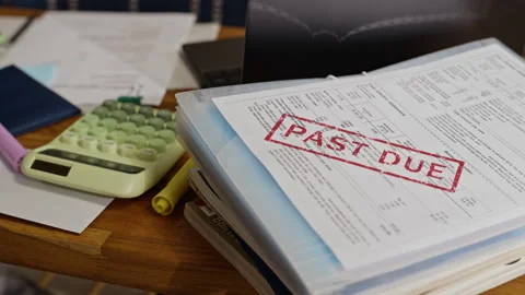 Stack of Unpaid Bills with Past Due Stamp Lying on Desk Stock Footage 344643003