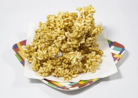 Stack of unshaped caramel puffed rice on plate. just cooked, without making p Stock Photos