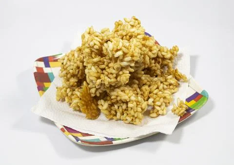 Stack of unshaped caramel puffed rice on plate. just cooked, without making p Stock Photos