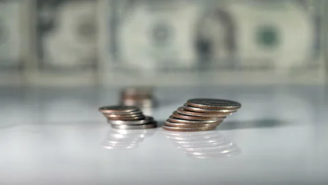 Stack of US coins with background of dollar bills. Stock Footage 149653872