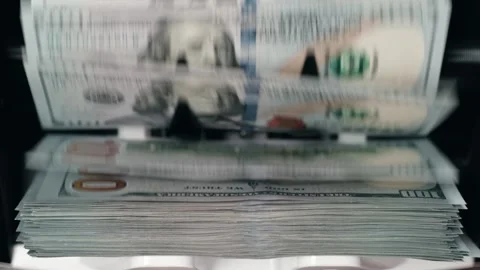 Stack of U.S. currency being processed through a cash counting machine, Stock Footage 333979073