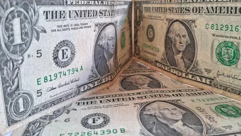 Stack of US dollar bills with coins. Financial success and wealth concept. Stock Photos