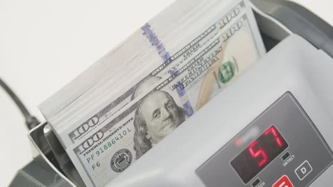 Stack of US Dollar Bills in Money Counting Machine with Digital Display Stock Footage 295418479