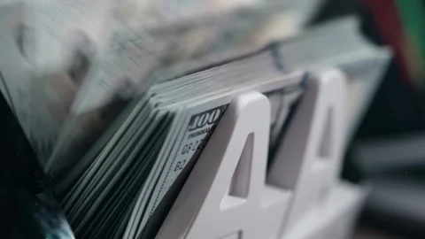 Stack of U.S. dollar bills organized in a money holder, showcasing the Stock Footage 333978833