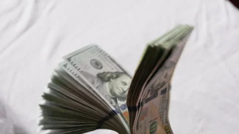 Stack of US dollar money waving in front of white background Stock Footage 329560660