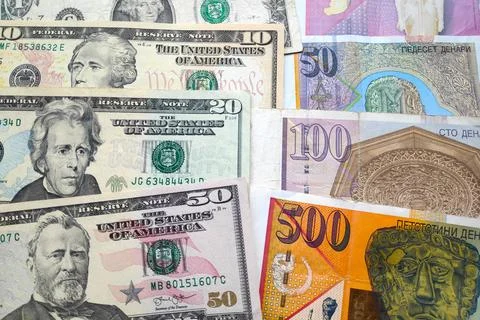 Stack of US Dollars and Macedonian denar Stock Photos
