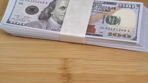 Stack of US dollars falls on the table. Counterfeiters check banknotes. Fight Stock Footage 246510145