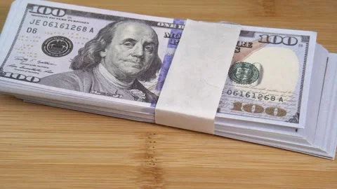 Stack of US dollars falls on the table. Counterfeiters check banknotes. Fight Stock Footage 246519149