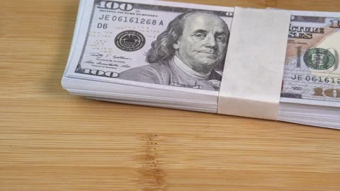 Stack of US dollars falls on the table. Counterfeiters check banknotes. Fight Stock Footage 246519156