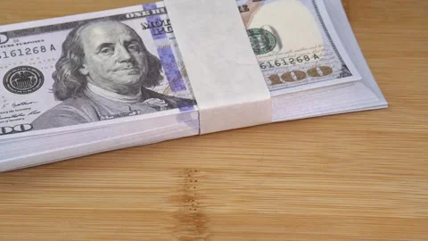 Stack of US dollars falls on the table. Counterfeiters check banknotes. Fight Stock Footage 246519190