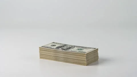 Stack of US Hundred Dollar Banknotes on Light Background Видео 347468805