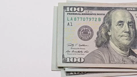 Stack of US hundred dollar bills placed on a light table with copy space Stock Footage 322751809