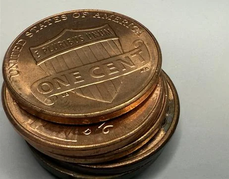 Stack of U.S. One Cent Penny Coins Close-Up on Neutral Background Stock Photos