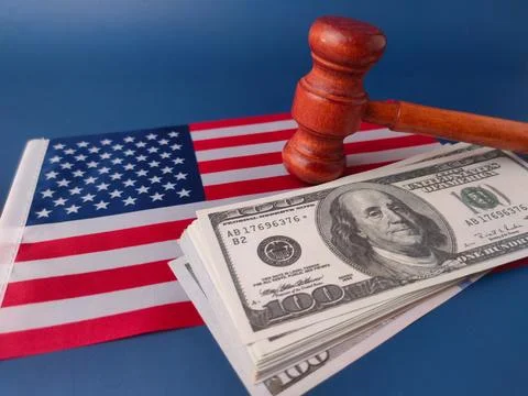 Stack of U.S. one-hundred dollar bills with a judge's gavel and a small Ame.. Stock Photos