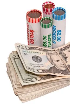 Stack of usa currency and rolls of coins Stock Photos