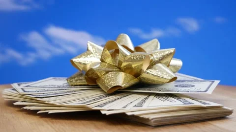 Stack of usa dollars and bow on blue  background, money gift concept Stock Footage 164478719