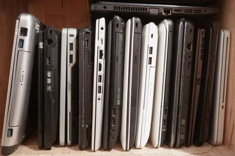 Stack of used laptops in different brand and models. That notebooks for repai Stock Photos