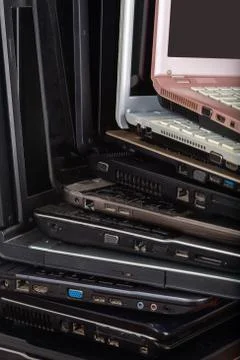 Stack of used laptops in different colors and models. T Stock Photos