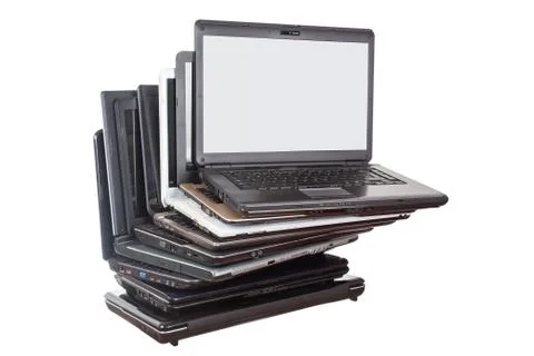Stack of used laptops in different colors and models. T Stock Photos