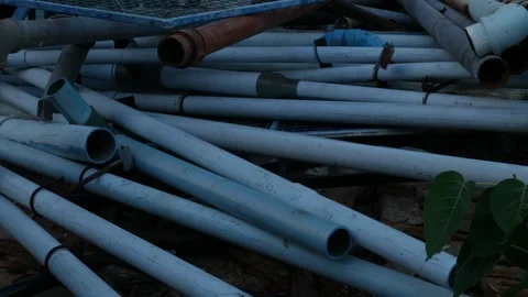 Stack of Used White and Blue PVC Pipes Stock Footage 326989544