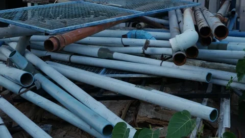 Stack of Used White and Blue PVC Pipes Stock Footage 326989586