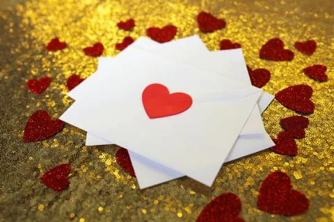 Stack of Valentine's Day Love Letters on Gold Background with Heart Confetti Stock Photos
