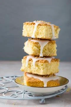 A stack of vanilla cake slices with icing and hazelnuts Foto stock